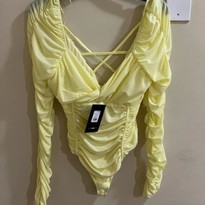 Brand new yellow body suit.